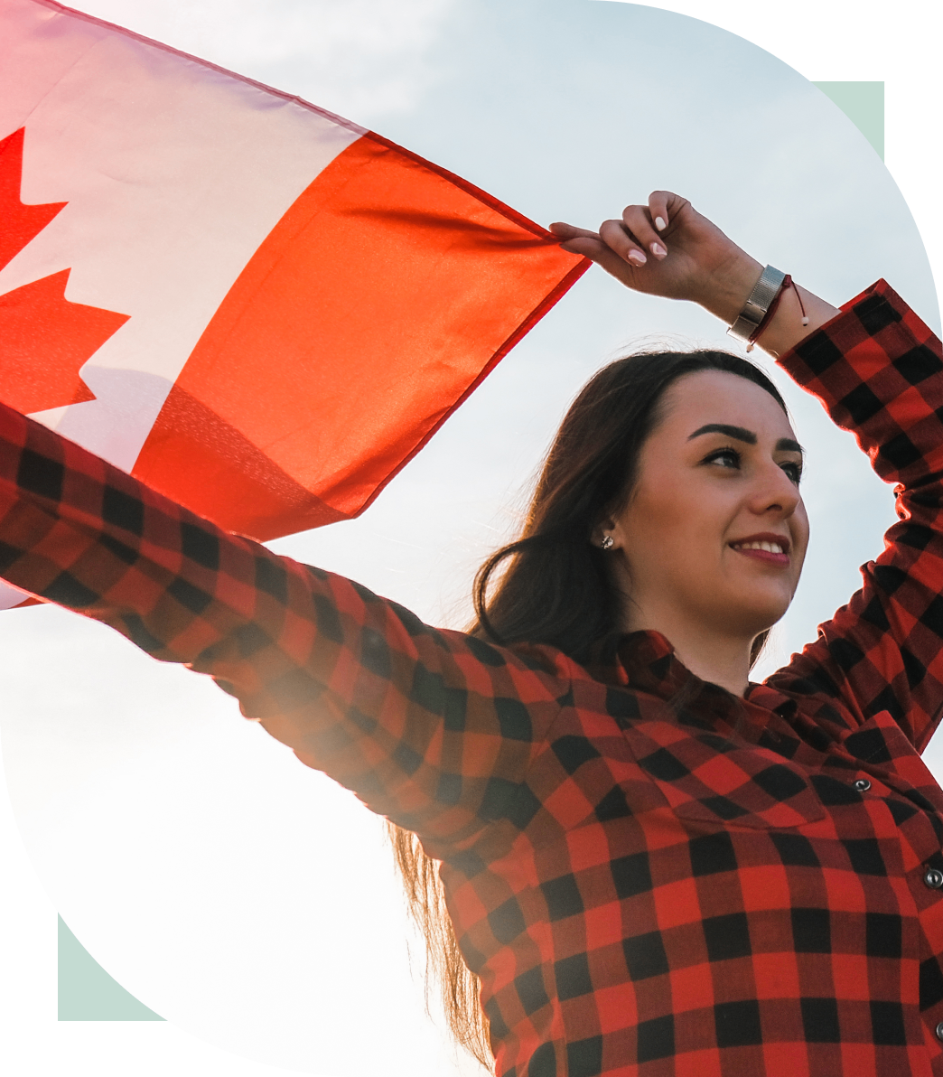 Woman waving a Canadian flag outdoors.